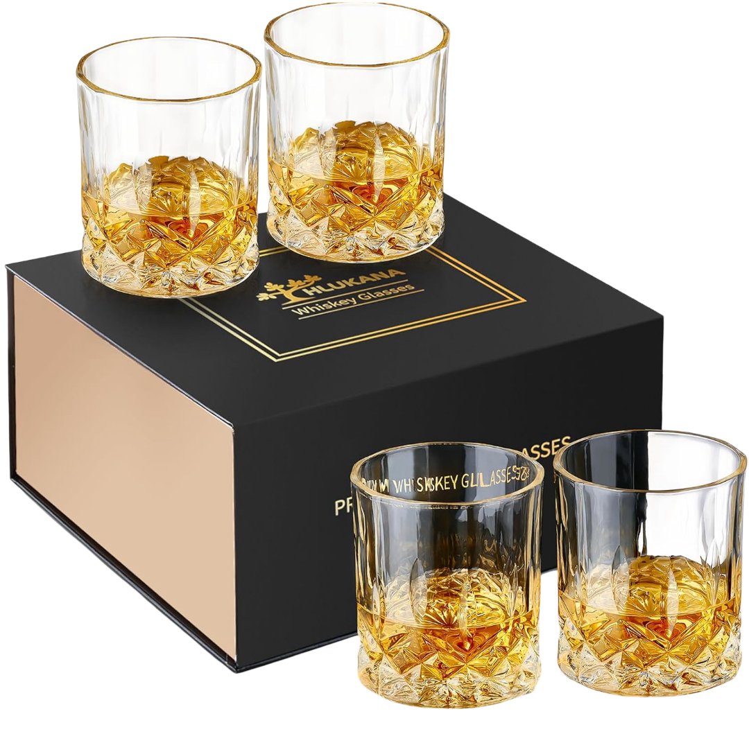 Four premium glass whiskey tumblers with diamond-cut pattern, filled with amber whiskey and ice balls, arranged around a black and gold Hlukana gift box